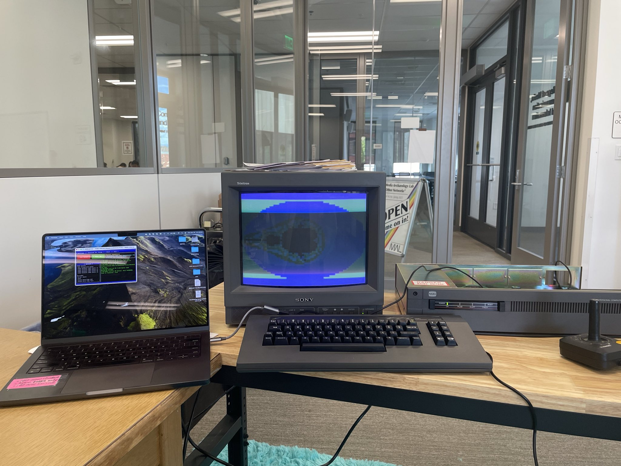 NABU computer connected to a macbook pro, displaying the nabu.ca retronet setup (Mandelbrot set displaying on the nabu screen)