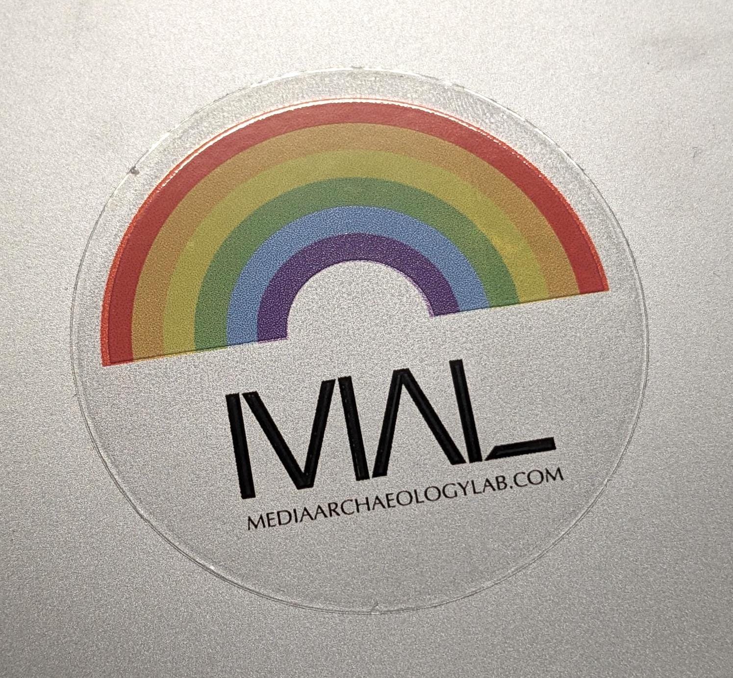 clear round sticker with rainbow graphic, MAL logo, and mediaarchaeologylab.com text