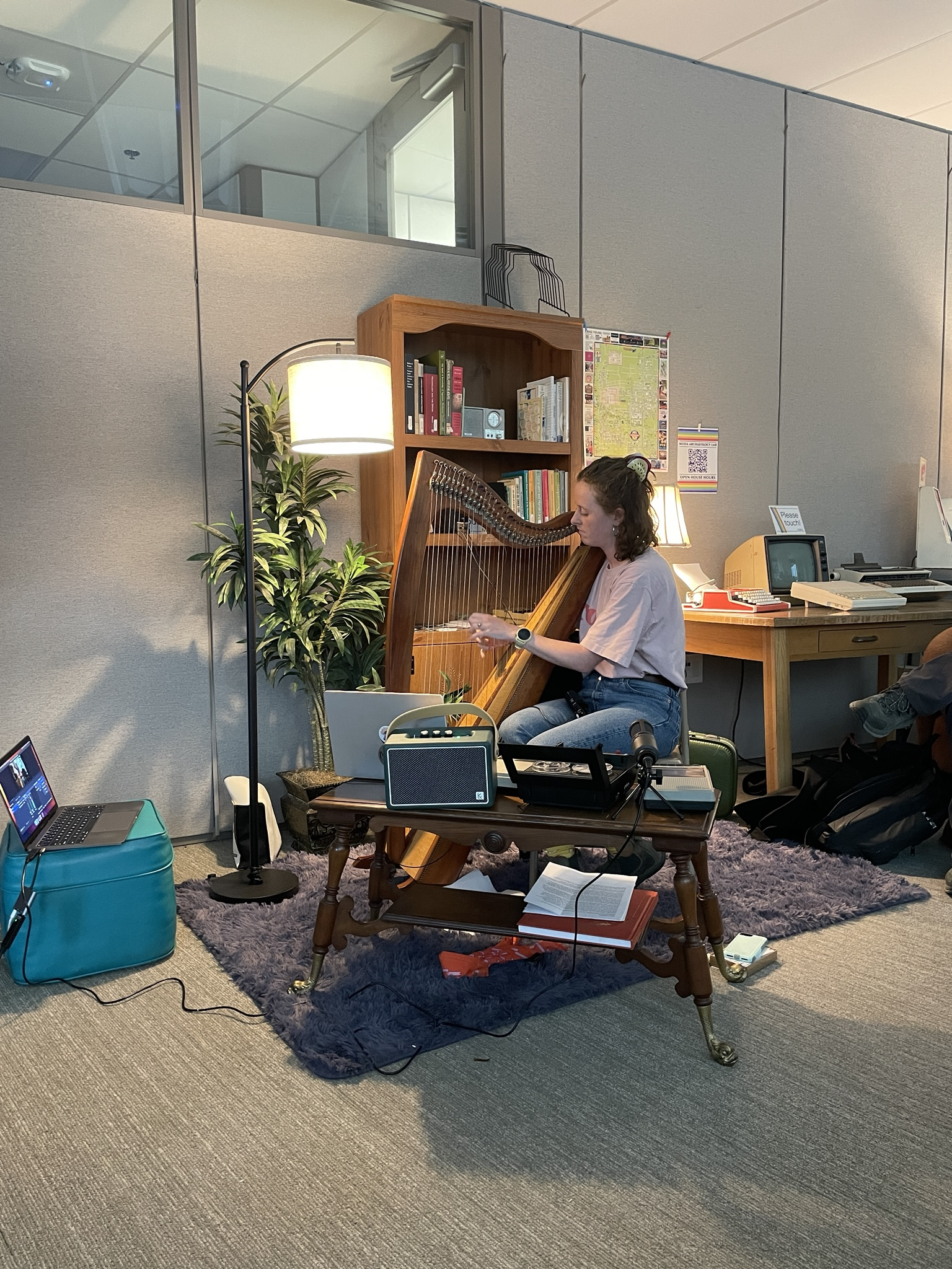 Niamh O'Brien plays the harp, an array of recording devices in front of her