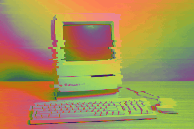 animated glitchy rainbow image of a Mac Classic II